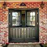 upvc double french doors in black with gold handles , top half open for display